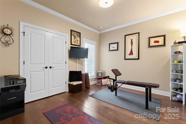 interior space featuring ornamental molding, dark wood-style flooring, and baseboards