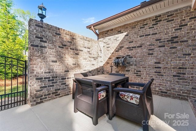 view of patio / terrace featuring outdoor dining area and fence