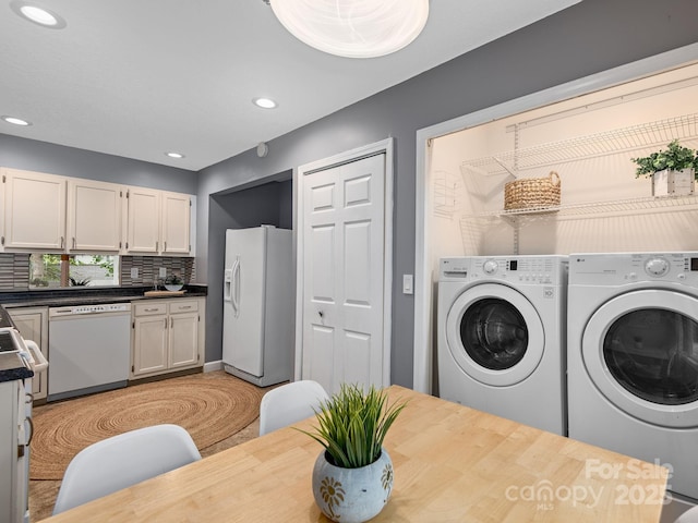 42 Hollybrook Dr, Asheville, NC 28803 - laundry room featuring washing machine and dryer, recessed lighting, and light wood-type flooring