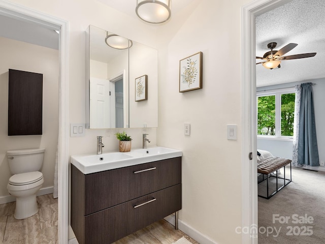42 Hollybrook Dr, Asheville, NC 28803 - bathroom with double vanity, baseboards, ceiling fan, and toilet