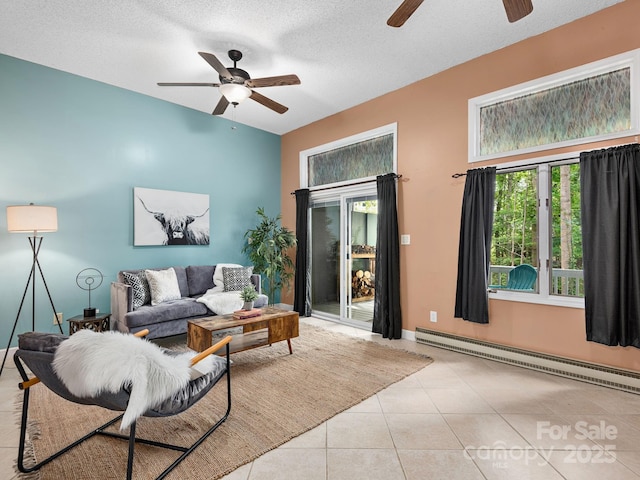 42 Hollybrook Dr, Asheville, NC 28803 - living area featuring ceiling fan, a baseboard heating unit, tile patterned flooring, a textured ceiling, and baseboards