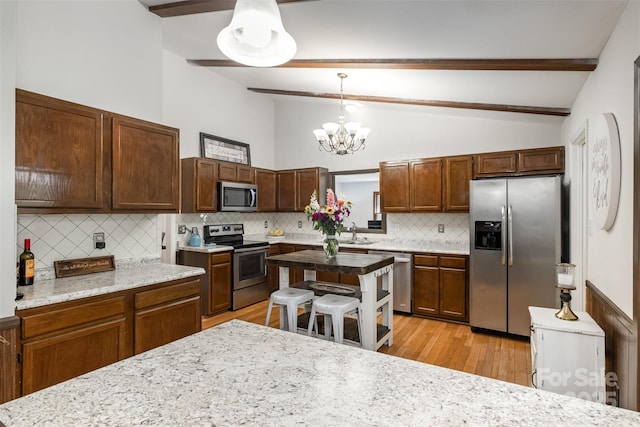 8544 Houston Ridge Rd, Charlotte, NC 28277 - kitchen with appliances with stainless steel finishes, beamed ceiling, tasteful backsplash, a chandelier, and light wood-style flooring