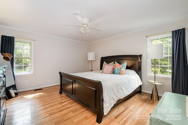 8544 Houston Ridge Rd, Charlotte, NC 28277 - bedroom with light wood-type flooring, multiple windows, baseboards, and crown molding