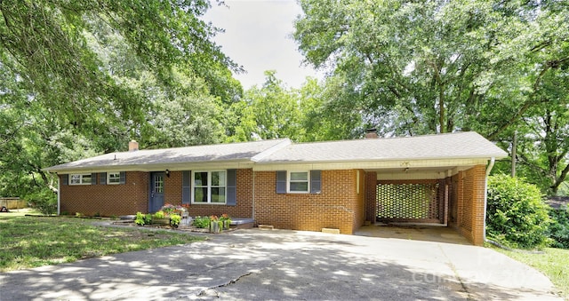 619 E Sanders Rd, Shelby, NC 28150 - ranch-style house featuring a chimney, concrete driveway, brick siding, and a carport