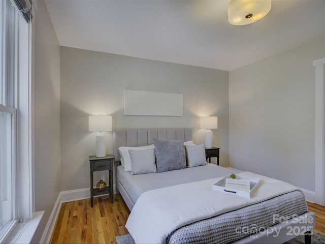 bedroom featuring light wood-type flooring and baseboards
