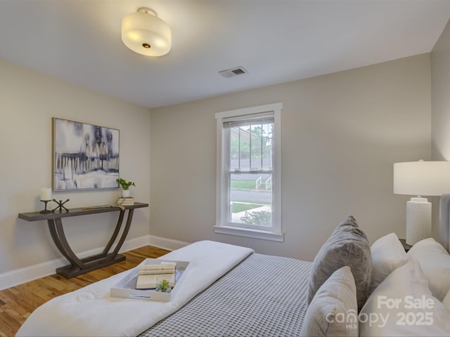 bedroom featuring baseboards and wood finished floors