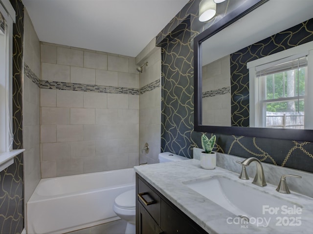 full bath with toilet, wallpapered walls, shower / bathtub combination, and vanity