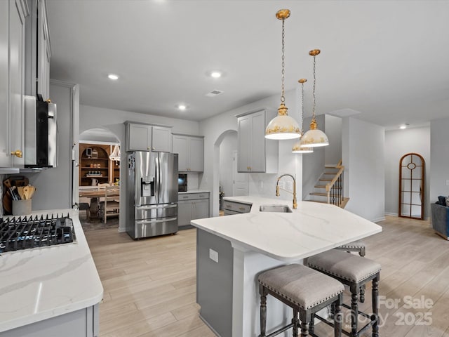 5581 Soft Shell Dr, Lancaster, SC 29720 - kitchen with stainless steel appliances, arched walkways, gray cabinets, and recessed lighting