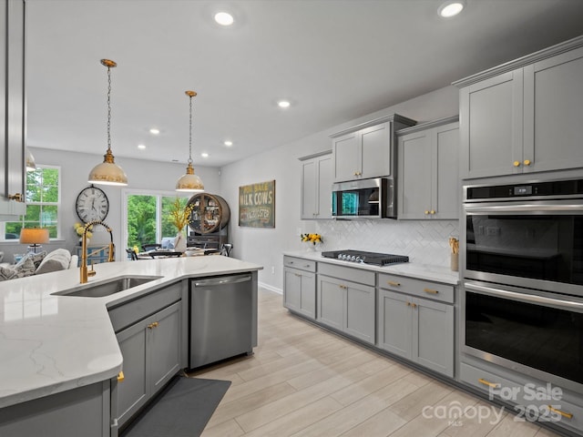 5581 Soft Shell Dr, Lancaster, SC 29720 - kitchen with stainless steel appliances, a sink, gray cabinetry, backsplash, and recessed lighting