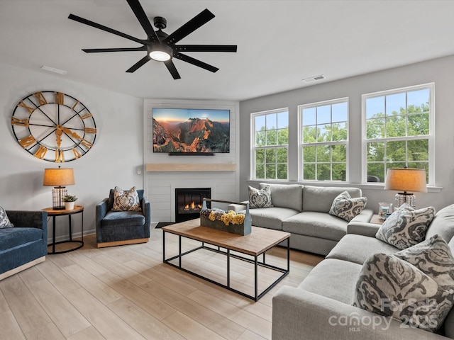5581 Soft Shell Dr, Lancaster, SC 29720 - living room with ceiling fan, a fireplace, and light wood-style floors