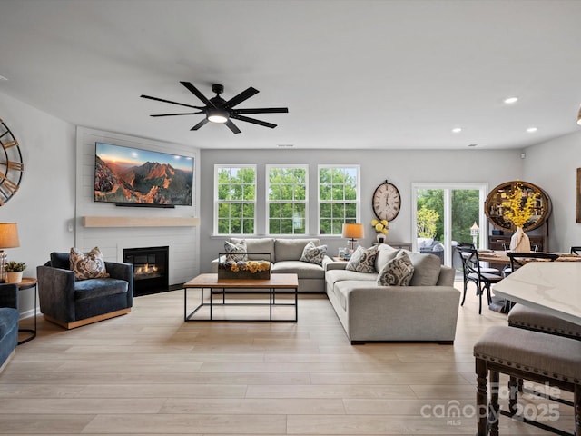 5581 Soft Shell Dr, Lancaster, SC 29720 - living area featuring a large fireplace, plenty of natural light, recessed lighting, a ceiling fan, and light wood finished floors