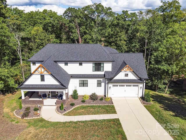 685 Knollcrest Dr NE, Concord, NC 28025 - modern farmhouse style home featuring board and batten siding, a porch, roof with shingles, and driveway