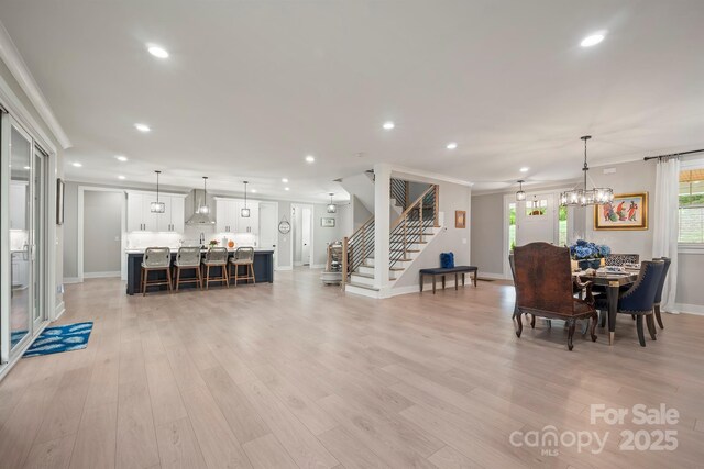 685 Knollcrest Dr NE, Concord, NC 28025 - dining area featuring stairs, baseboards, recessed lighting, light wood-type flooring, and a chandelier