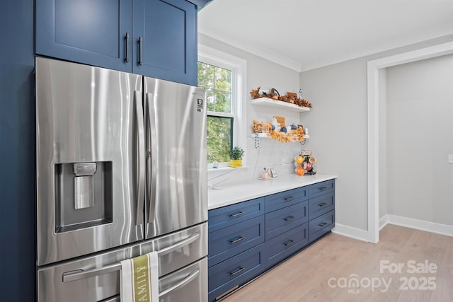 685 Knollcrest Dr NE, Concord, NC 28025 - kitchen with stainless steel fridge with ice dispenser, light wood-type flooring, blue cabinets, light countertops, and open shelves