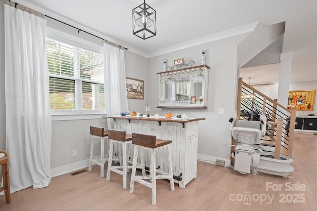 685 Knollcrest Dr NE, Concord, NC 28025 - indoor bar with light wood finished floors, baseboards, and ornamental molding