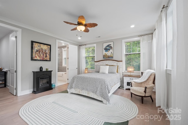 685 Knollcrest Dr NE, Concord, NC 28025 - bedroom with multiple windows, wood finished floors, ornamental molding, recessed lighting, and a fireplace