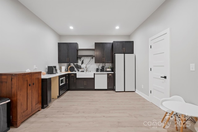 685 Knollcrest Dr NE, Concord, NC 28025 - kitchen with white appliances, a sink, light countertops, light wood-style floors, and recessed lighting