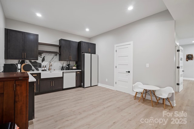 685 Knollcrest Dr NE, Concord, NC 28025 - kitchen featuring freestanding refrigerator, dishwashing machine, a sink, light wood-type flooring, and recessed lighting