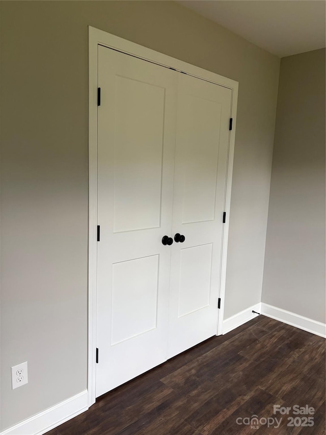 8222 Madison Ln, Hickory, NC 28602 - unfurnished bedroom with baseboards, dark wood-style floors, and a closet