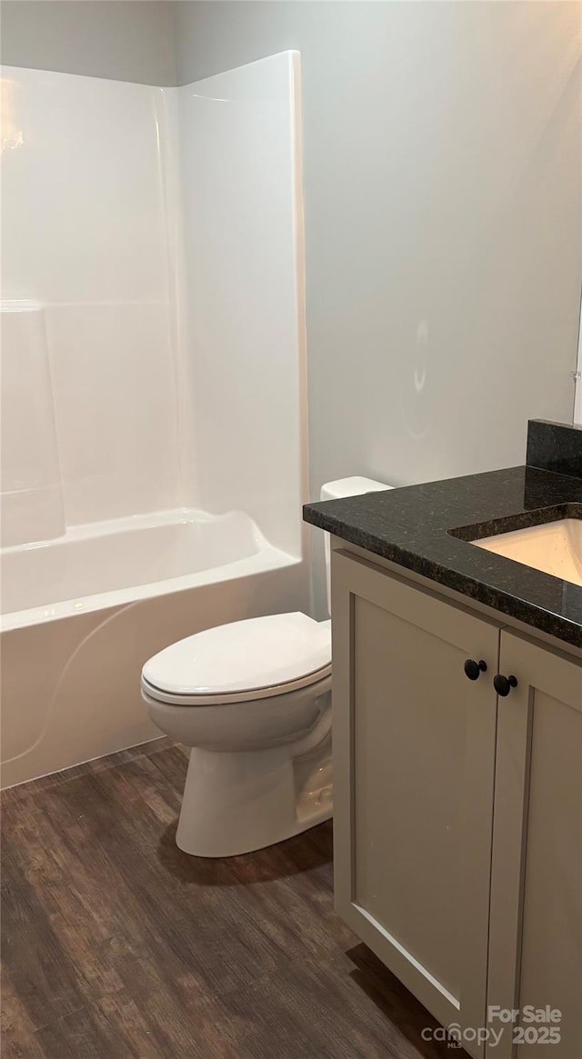8222 Madison Ln, Hickory, NC 28602 - full bath with wood finished floors, toilet, vanity, and shower / washtub combination