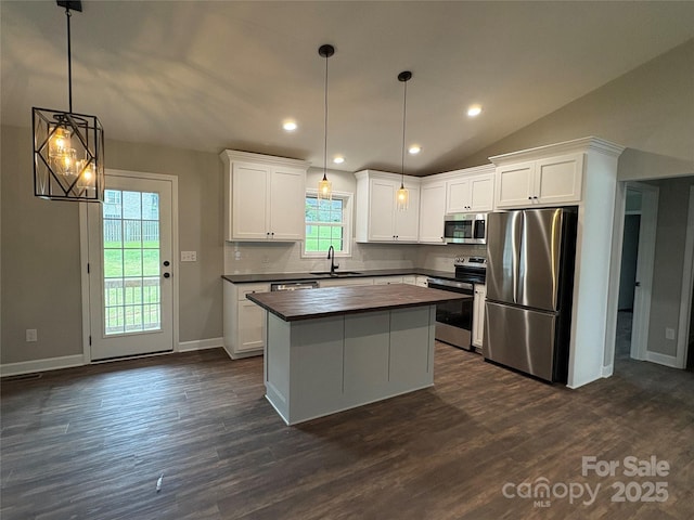 8222 Madison Ln, Hickory, NC 28602 - kitchen with appliances with stainless steel finishes, butcher block counters, a sink, tasteful backsplash, and dark wood-type flooring