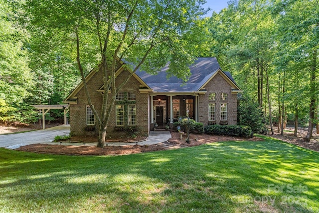 131 Sierra Woods Dr, Troutman, NC 28166 - view of front of house with brick siding, a front lawn, a carport, and driveway