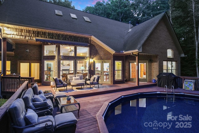 131 Sierra Woods Dr, Troutman, NC 28166 - back of house featuring an outdoor living space, a deck, french doors, brick siding, and an outdoor pool