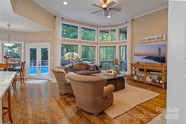 131 Sierra Woods Dr, Troutman, NC 28166 - living area featuring french doors, ceiling fan, crown molding, wood finished floors, and plenty of natural light