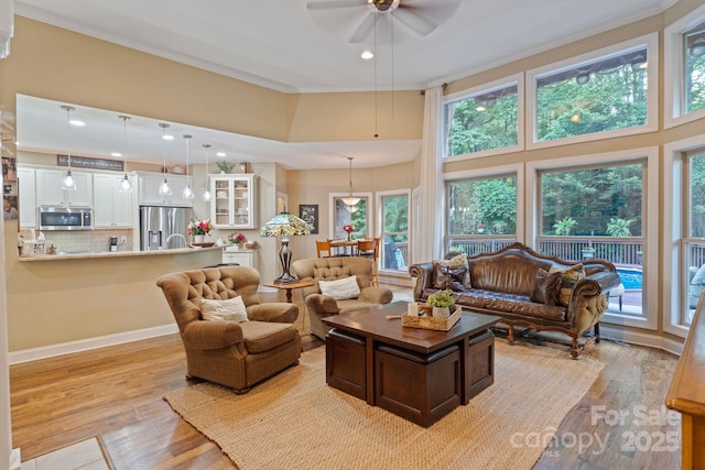 131 Sierra Woods Dr, Troutman, NC 28166 - living room with ceiling fan, light wood-type flooring, a towering ceiling, crown molding, and recessed lighting