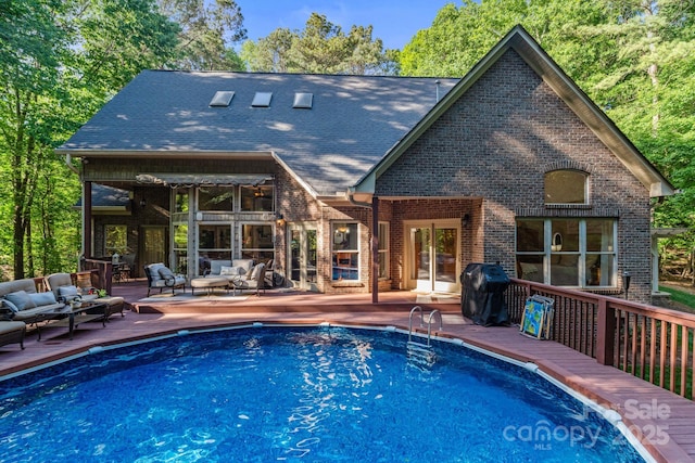 131 Sierra Woods Dr, Troutman, NC 28166 - swimming pool featuring an outdoor living space, french doors, a wooden deck, and grilling area
