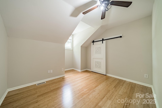 3387 Passmore Rd, Rock Hill, SC 29730 - bonus room with a ceiling fan, wood finished floors, a barn door, baseboards, and lofted ceiling