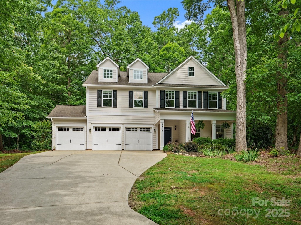 5308 Lambert Ct, Waxhaw, NC 28173 - view of front facade featuring driveway, an attached garage, a front lawn, roof with shingles, and a porch