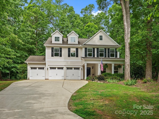 5308 Lambert Ct, Waxhaw, NC 28173 - view of front facade featuring driveway, an attached garage, a front lawn, roof with shingles, and a porch