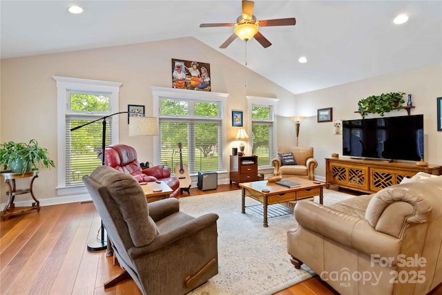 living room with lofted ceiling, a ceiling fan, light wood-style flooring, recessed lighting, and baseboards