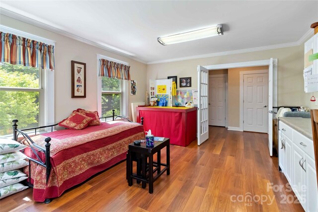 bedroom featuring crown molding and wood finished floors