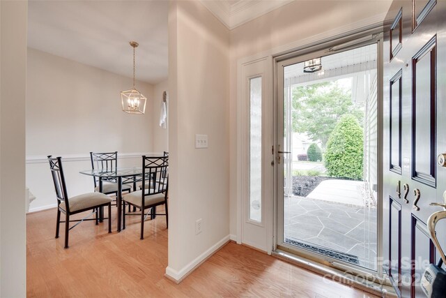 422 Garnet Ct, Fort Mill, SC 29708 - entrance foyer featuring a chandelier, light wood finished floors, and crown molding