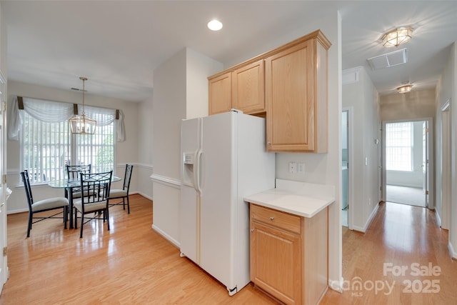 422 Garnet Ct, Fort Mill, SC 29708 - kitchen featuring white refrigerator with ice dispenser, light brown cabinetry, light wood-style floors, light countertops, and decorative light fixtures