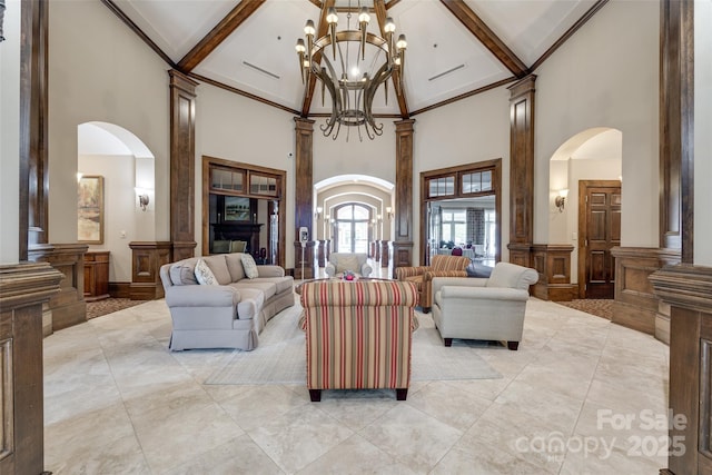422 Garnet Ct, Fort Mill, SC 29708 - living area featuring a high ceiling, arched walkways, a chandelier, light tile patterned flooring, and beam ceiling