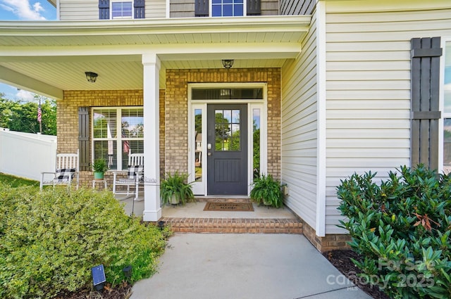 6314 Bluffton Ln, Midland, NC 28107 - property entrance with brick siding, a porch, and fence