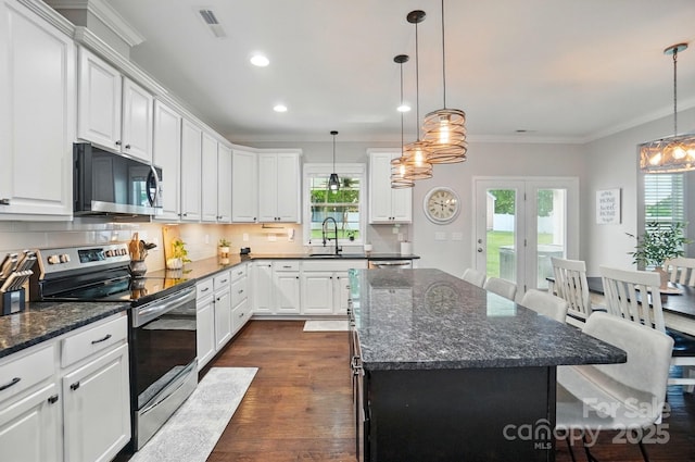 6314 Bluffton Ln, Midland, NC 28107 - kitchen with stainless steel electric range, a sink, plenty of natural light, ornamental molding, and recessed lighting