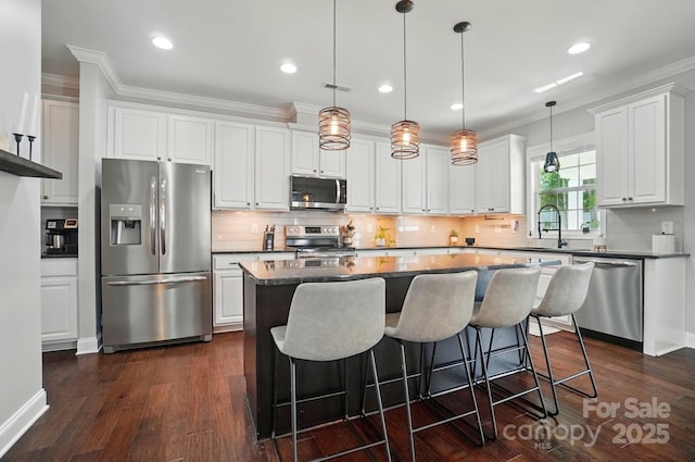 6314 Bluffton Ln, Midland, NC 28107 - kitchen featuring stainless steel appliances, ornamental molding, dark wood-style flooring, a center island, and tasteful backsplash