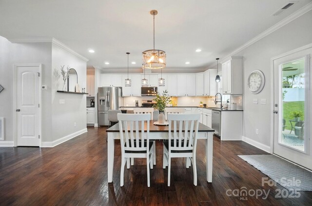 6314 Bluffton Ln, Midland, NC 28107 - dining area featuring ornamental molding, baseboards, dark wood-style floors, recessed lighting, and a chandelier