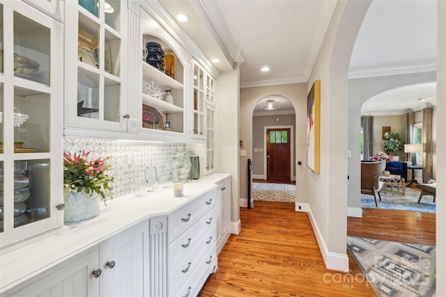 1701 Dearmon Dr, Charlotte, NC 28205 - corridor with arched walkways, crown molding, light wood finished floors, baseboards, and recessed lighting