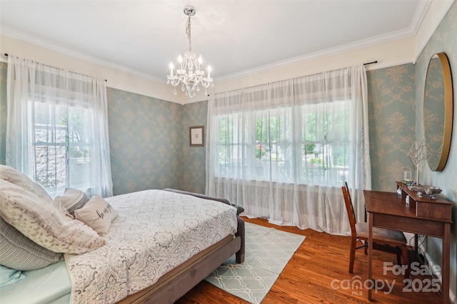 1701 Dearmon Dr, Charlotte, NC 28205 - bedroom with multiple windows, a chandelier, wood finished floors, ornamental molding, and wallpapered walls