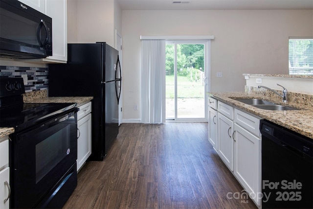 6717 Ware Rd, Charlotte, NC 28212 - kitchen with black appliances, a sink, dark wood-style flooring, and white cabinetry