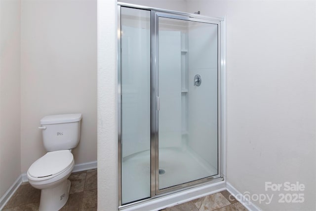 6717 Ware Rd, Charlotte, NC 28212 - bathroom featuring baseboards, a stall shower, and toilet