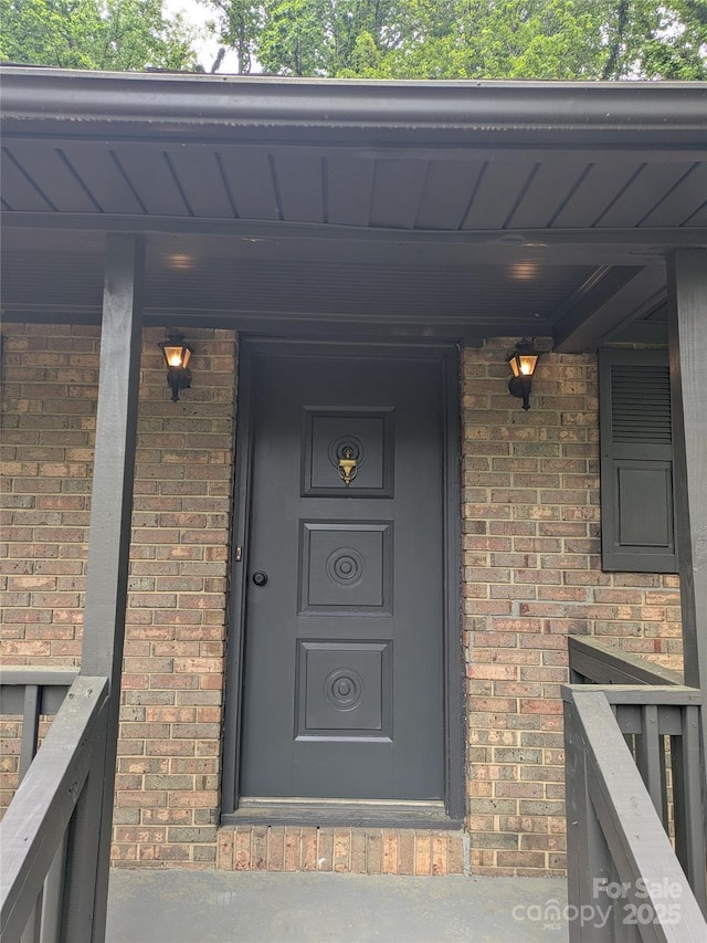 property entrance with brick siding
