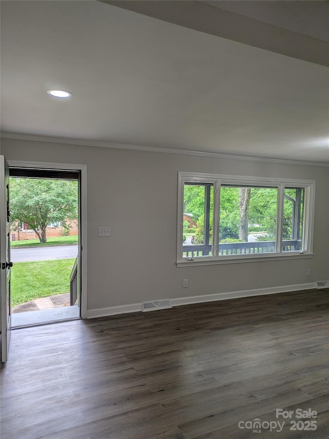 unfurnished room featuring dark wood finished floors, baseboards, crown molding, and recessed lighting