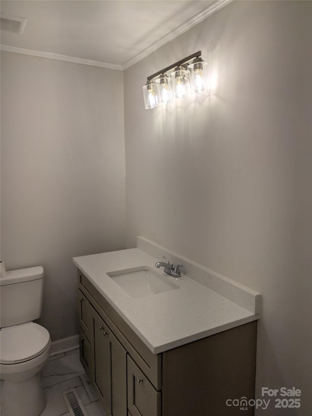 bathroom featuring vanity, toilet, and ornamental molding