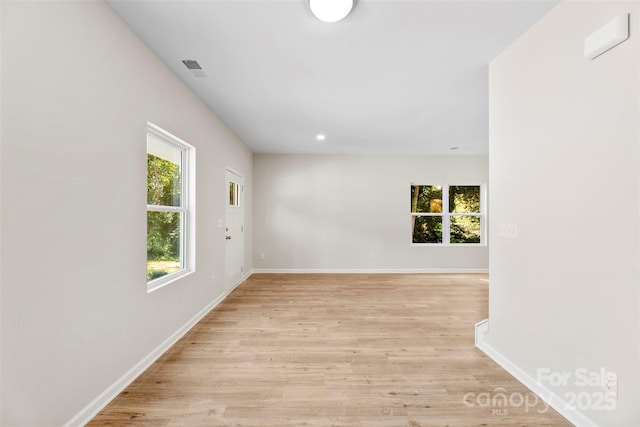 unfurnished room with light wood-style floors, baseboards, and recessed lighting